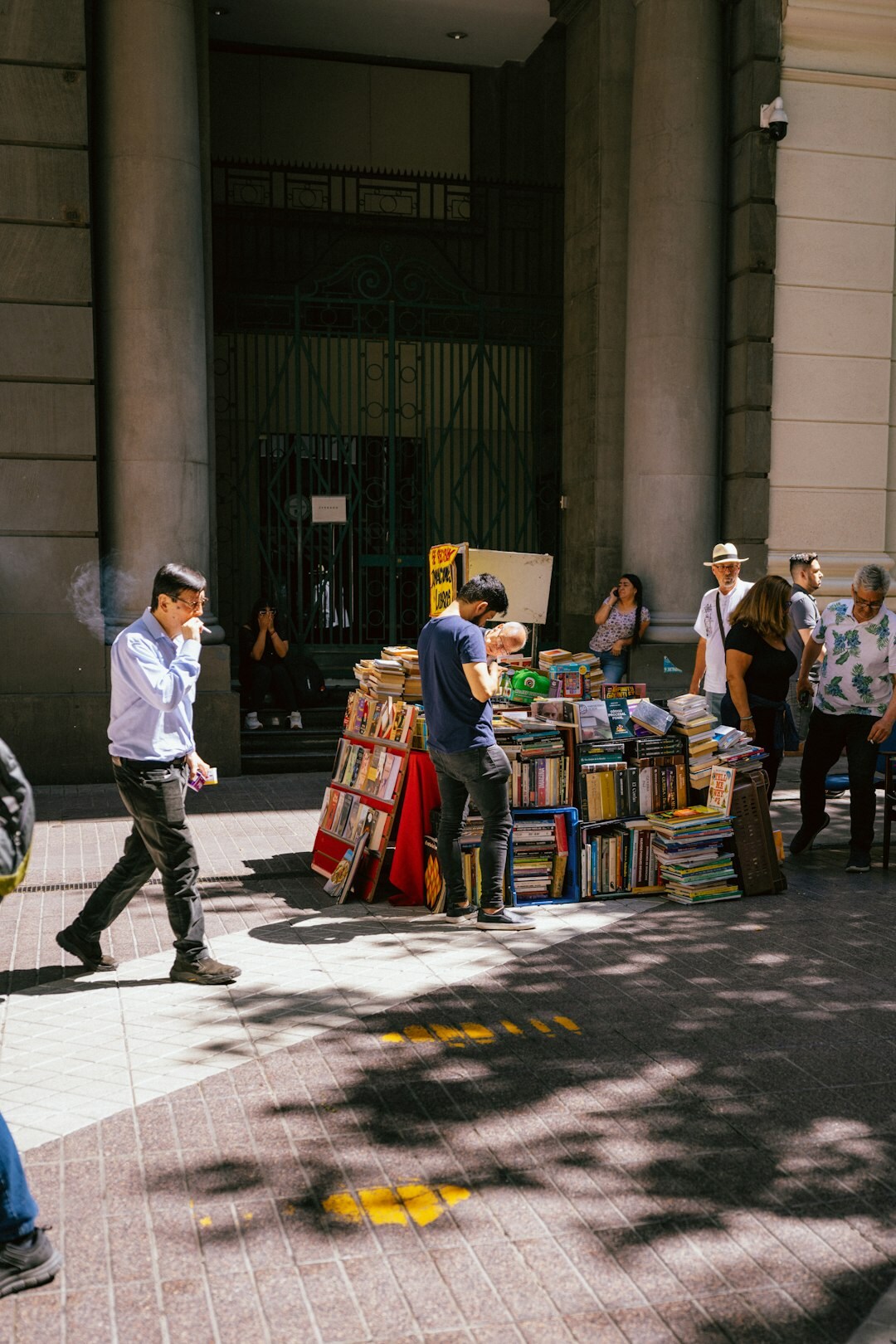 Documentary photo of a busy street in Santiago Chile with pedestrians and old buildings at golden hour