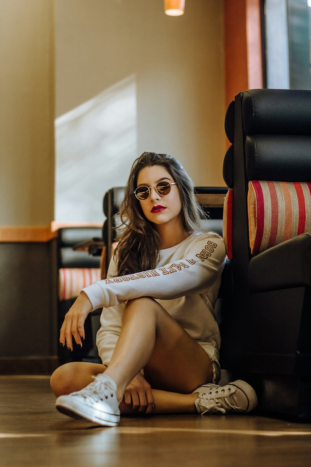 Candid portrait of a Chilean woman sitting in a doorway in her neighborhood
