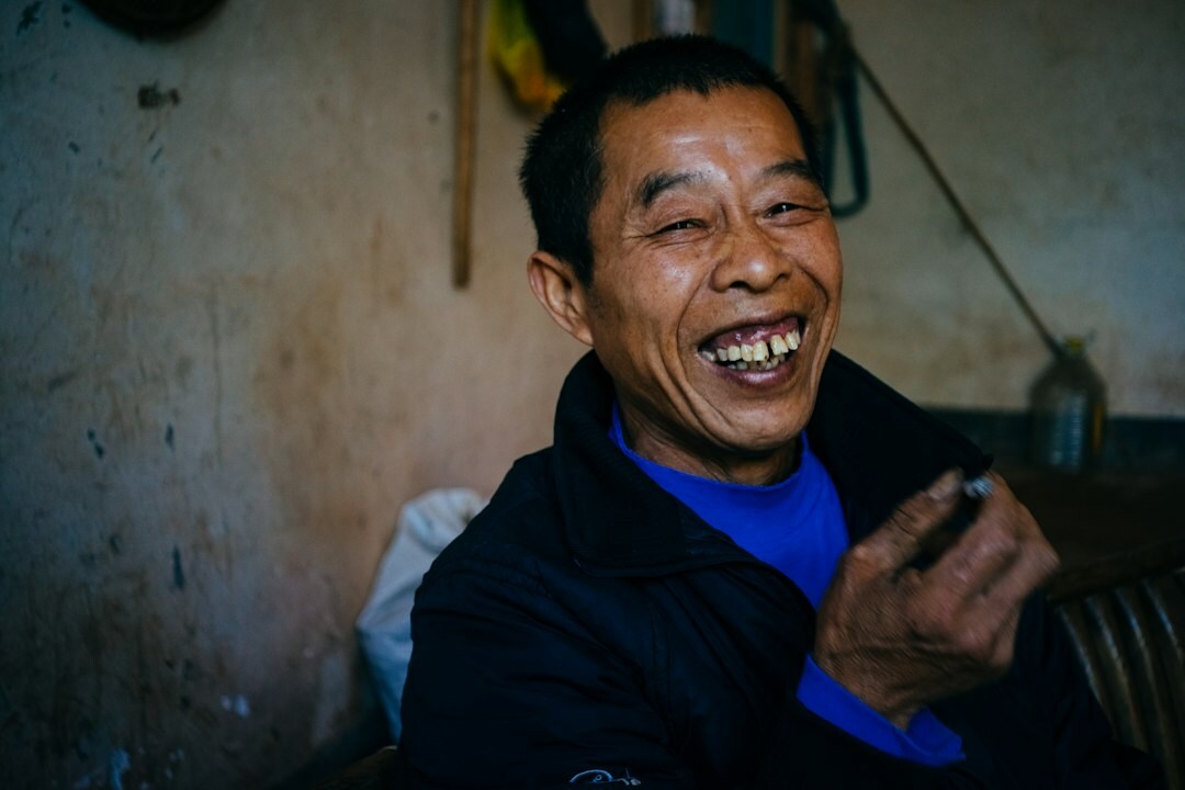 Candid portrait of a Chilean man laughing with neighbors on his street