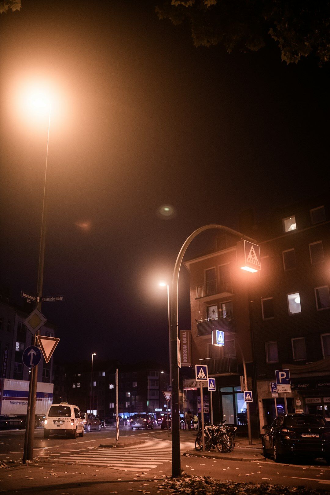 City street at night lit by streetlights with long exposure light trails