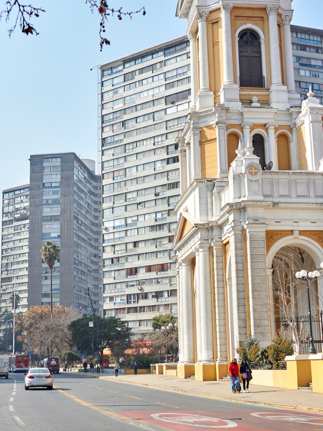 Downtown city street with mixed architecture and public transportation in Chile